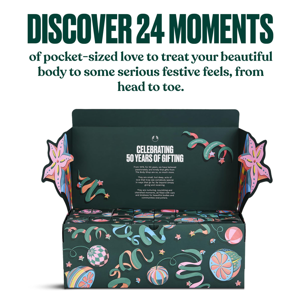 Open advent calendar box showing 24 numbered compartments inside with festive swirl and ornament print