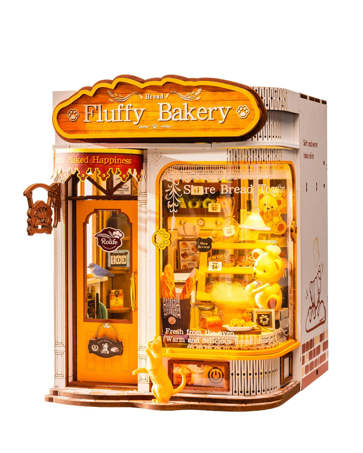 A 3D wooden model kit of a bakery storefront named 'Fluffy Bakery', featuring a detailed door, window display with plush toys, and decorative elements, shown on a solid white background.