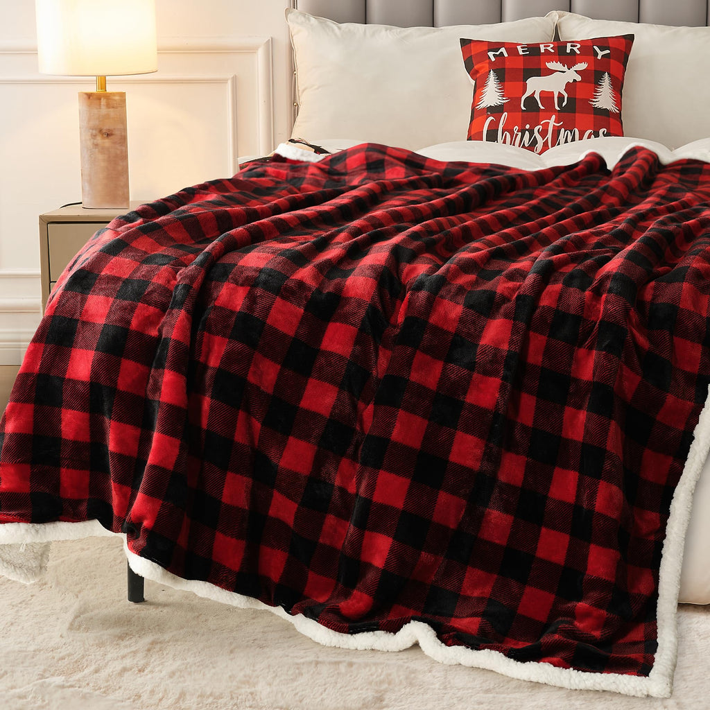  Red and black buffalo plaid sherpa throw blanket spread across a bed with a matching Merry Christmas moose pillow and gold lamp on nightstand