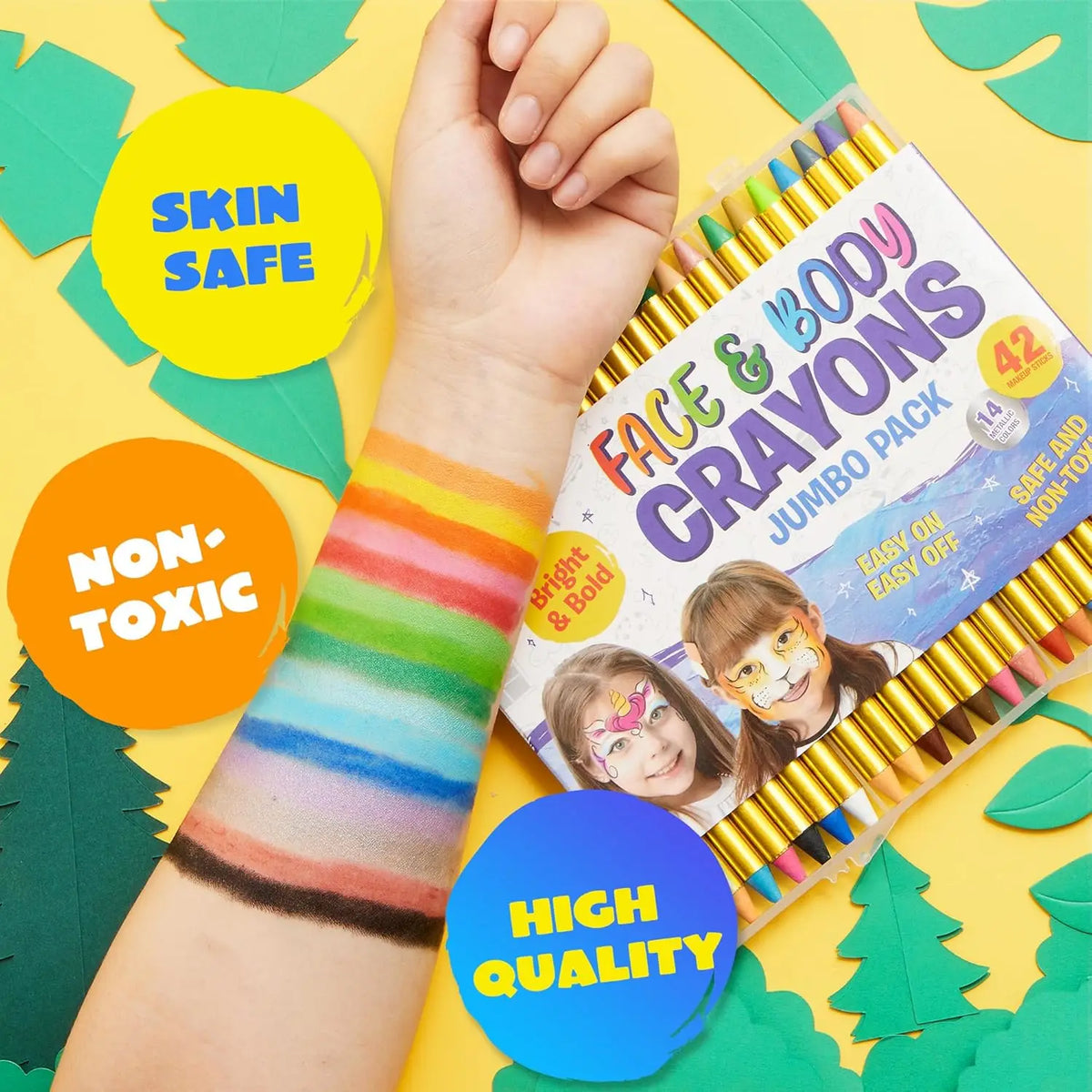 Face and body crayons with a child's hand wearing colorful wrist paint, on a yellow background with leaf decorations.