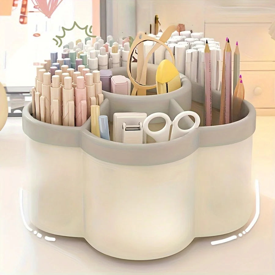 White 360-degree rotating desk organizer filled with pastel markers colored pencils tape dispenser and scissors on a white desk surface with colorful room decor in background